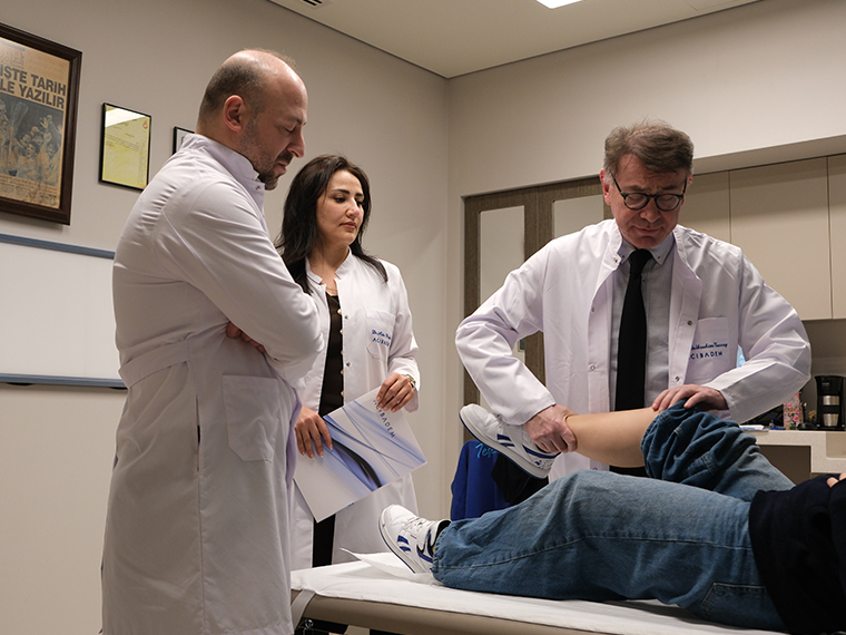 IJC physicians evaluating a patient during a joint examination